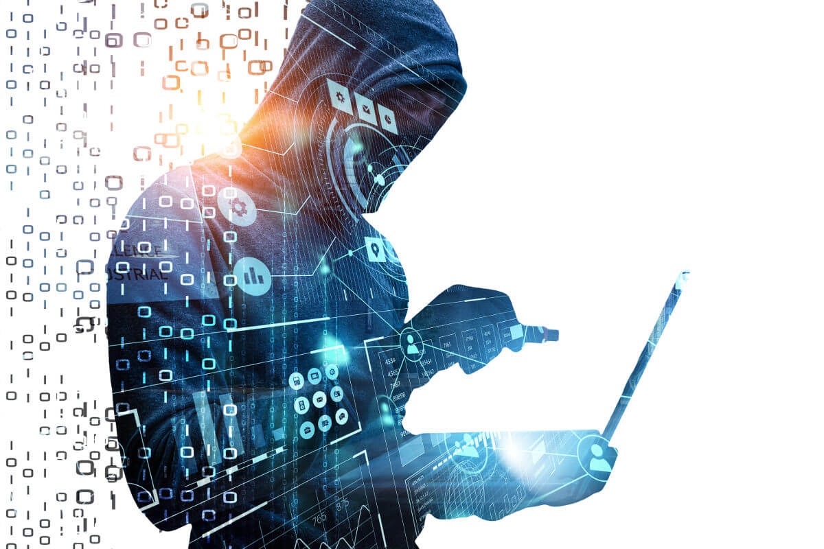 Hacker working in shadows